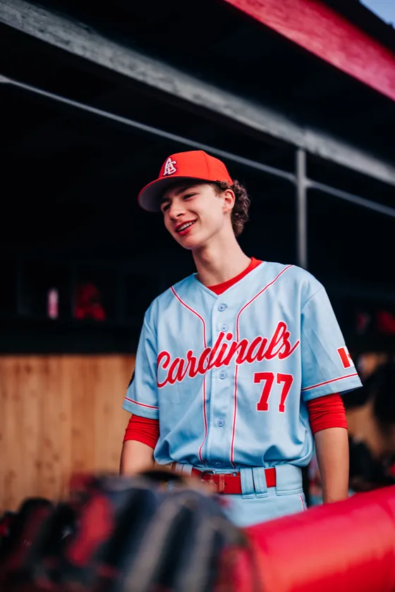 An Abbotsford Cardinals player in the red jersey against a dark ground.