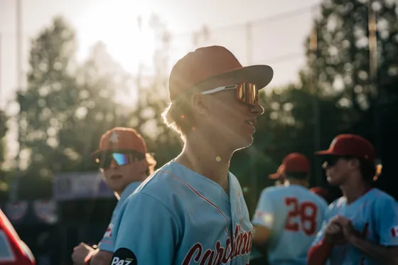 An Abbotsford Cardinals coach backlit at sunset.
